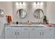 Modern bathroom with double sinks, granite countertops, and large mirrors at 12940 Brookside Moss Dr, Riverview, FL 33579