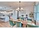 Open concept dining room with modern chandelier at 12940 Brookside Moss Dr, Riverview, FL 33579