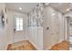 Stylish entryway with wood floors, wainscoting, and modern wall decor at 12940 Brookside Moss Dr, Riverview, FL 33579