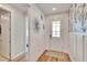 Elegant entryway showcasing wood floors, a patterned rug, and a coat closet at 12940 Brookside Moss Dr, Riverview, FL 33579