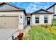 Beautiful one-story house featuring a two-car garage and nicely landscaped front yard at 12940 Brookside Moss Dr, Riverview, FL 33579