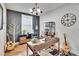 Home office with wood desk, guitars, and a large clock at 12940 Brookside Moss Dr, Riverview, FL 33579