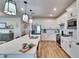 Modern kitchen with white cabinets, quartz countertops and stainless steel appliances at 12940 Brookside Moss Dr, Riverview, FL 33579