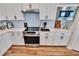 Modern kitchen featuring stainless steel appliances and white cabinets at 12940 Brookside Moss Dr, Riverview, FL 33579
