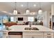 Kitchen island with sink, and overlooks the living room at 12940 Brookside Moss Dr, Riverview, FL 33579