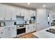 Modern kitchen with stainless steel appliances and white cabinets at 12940 Brookside Moss Dr, Riverview, FL 33579