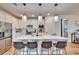 Modern kitchen with white cabinets, quartz countertops and island at 12940 Brookside Moss Dr, Riverview, FL 33579
