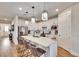 Modern kitchen with white cabinets, quartz countertops and island at 12940 Brookside Moss Dr, Riverview, FL 33579