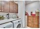 Spacious laundry room with washer, dryer, and ample storage space at 12940 Brookside Moss Dr, Riverview, FL 33579