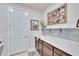 Bright laundry room with washer, dryer, cabinets, and a utility sink at 12940 Brookside Moss Dr, Riverview, FL 33579