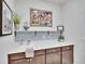Laundry room features a sink, cabinets, and decorative tile backsplash at 12940 Brookside Moss Dr, Riverview, FL 33579