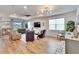 Spacious living room with hardwood floors, comfortable seating, and a view of the backyard at 12940 Brookside Moss Dr, Riverview, FL 33579