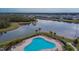 Community pool with lounge chairs; overlooking a lake at 12940 Brookside Moss Dr, Riverview, FL 33579