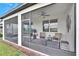 Comfortable screened porch with wicker furniture at 12940 Brookside Moss Dr, Riverview, FL 33579