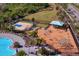 Community pool and playground with palm trees and surrounding landscape at 13614 Tonya Anne Dr, Riverview, FL 33579