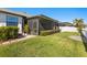 Spacious backyard with grassy area and screened patio at 13614 Tonya Anne Dr, Riverview, FL 33579