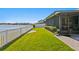 Landscaped backyard with a screened patio and lake view at 13614 Tonya Anne Dr, Riverview, FL 33579