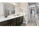 Double vanity bathroom with a walk-in shower and large closet at 13614 Tonya Anne Dr, Riverview, FL 33579