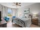Bedroom with a king-size bed, blue armchairs, and water views at 13614 Tonya Anne Dr, Riverview, FL 33579
