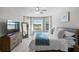 King size bed in bedroom with large windows and a dresser at 13614 Tonya Anne Dr, Riverview, FL 33579
