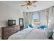 Bedroom with king-size bed and dresser; view of lake at 13614 Tonya Anne Dr, Riverview, FL 33579