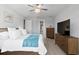 Main bedroom with walk-in closet and large TV at 13614 Tonya Anne Dr, Riverview, FL 33579