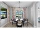 Bright dining area with charming floral curtains and a round table at 13614 Tonya Anne Dr, Riverview, FL 33579
