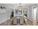 Bright dining room with farmhouse table, wicker chairs, and a stylish light fixture at 13614 Tonya Anne Dr, Riverview, FL 33579