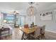Open concept dining room with a rustic wooden table and wicker chairs at 13614 Tonya Anne Dr, Riverview, FL 33579