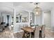 Open concept dining room with rustic wooden table and wicker chairs at 13614 Tonya Anne Dr, Riverview, FL 33579