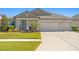 Two-story home with a three-car garage and well-maintained lawn at 13614 Tonya Anne Dr, Riverview, FL 33579