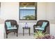 Relaxing front porch with wicker chairs, side table, and potted plants at 13614 Tonya Anne Dr, Riverview, FL 33579