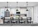 Modern kitchen with white cabinets, granite island, and pendant lighting at 13614 Tonya Anne Dr, Riverview, FL 33579