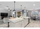Open kitchen with large island, granite countertops, and stainless steel appliances at 13614 Tonya Anne Dr, Riverview, FL 33579