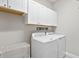 Laundry room with washer, dryer and cabinets at 13614 Tonya Anne Dr, Riverview, FL 33579