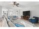 Spacious living room with large TV, comfy seating, and access to backyard at 13614 Tonya Anne Dr, Riverview, FL 33579