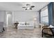 Living area with white couch, wood floors, and ceiling fan at 13614 Tonya Anne Dr, Riverview, FL 33579
