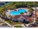 Community pool with adjacent clubhouse, surrounded by palms at 13614 Tonya Anne Dr, Riverview, FL 33579