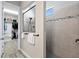 Walk-in shower with tile surround and a window at 13614 Tonya Anne Dr, Riverview, FL 33579