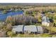 Aerial view of residential buildings near a lake and lush trees at 1433 Pine Glen Pl # D1, Tarpon Springs, FL 34688