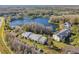 Aerial perspective of residential buildings, a lake, and surrounding nature at 1433 Pine Glen Pl # D1, Tarpon Springs, FL 34688