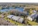 Aerial view showcasing a tranquil lakefront community at 1433 Pine Glen Pl # D1, Tarpon Springs, FL 34688