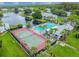 Community tennis courts and pool with surrounding landscape at 1433 Pine Glen Pl # D1, Tarpon Springs, FL 34688