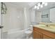 Bathroom with tub, shower, and wood vanity at 1433 Pine Glen Pl # D1, Tarpon Springs, FL 34688