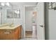 Bathroom with wood vanity and hallway access at 1433 Pine Glen Pl # D1, Tarpon Springs, FL 34688