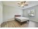 Bright bedroom with wood-look floors and ceiling fan at 1433 Pine Glen Pl # D1, Tarpon Springs, FL 34688
