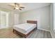 Bedroom with bathroom access and ceiling fan at 1433 Pine Glen Pl # D1, Tarpon Springs, FL 34688