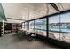 Bright room with pool view, table, chairs, and bookshelves at 1433 Pine Glen Pl # D1, Tarpon Springs, FL 34688
