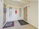 Condo entryway with two doors and a red fire extinguisher at 1433 Pine Glen Pl # D1, Tarpon Springs, FL 34688