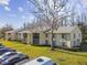 Condo building exterior with trees and parking at 1433 Pine Glen Pl # D1, Tarpon Springs, FL 34688